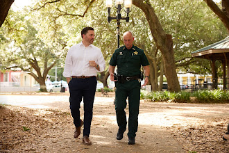 Mayor Reeves walking with a sheriff's deputy